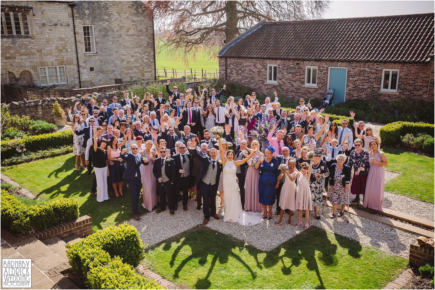 A photo of everyone at a spring wedding at Priory Cottages in Yorkshire, Priory Cottages Yorkshire, The Priory Syningthwaite, Yorkshire Barn wedding venues