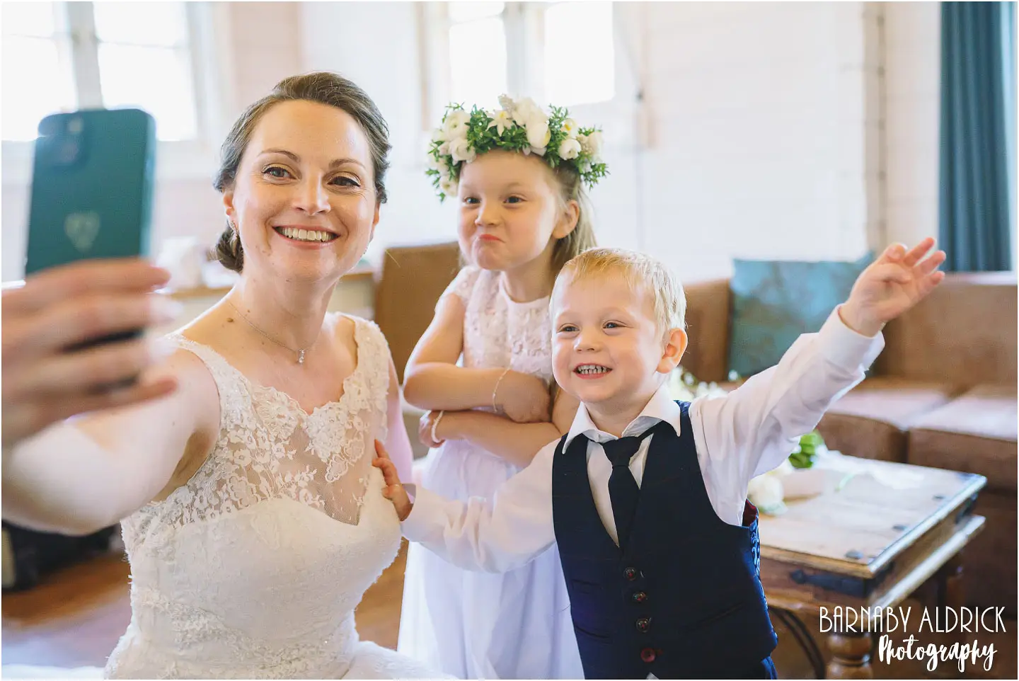 Fun Bridal selfie wedding photo at Chevin Country Park in Otley with their flower girl and page boy children