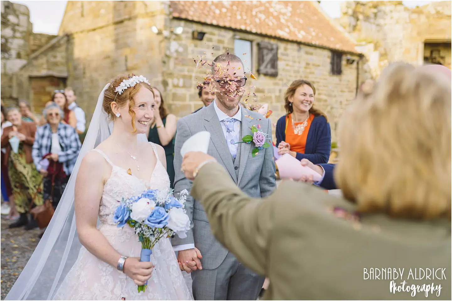 Wedding confetti photo at Danby Castle Barn in Yorkshire