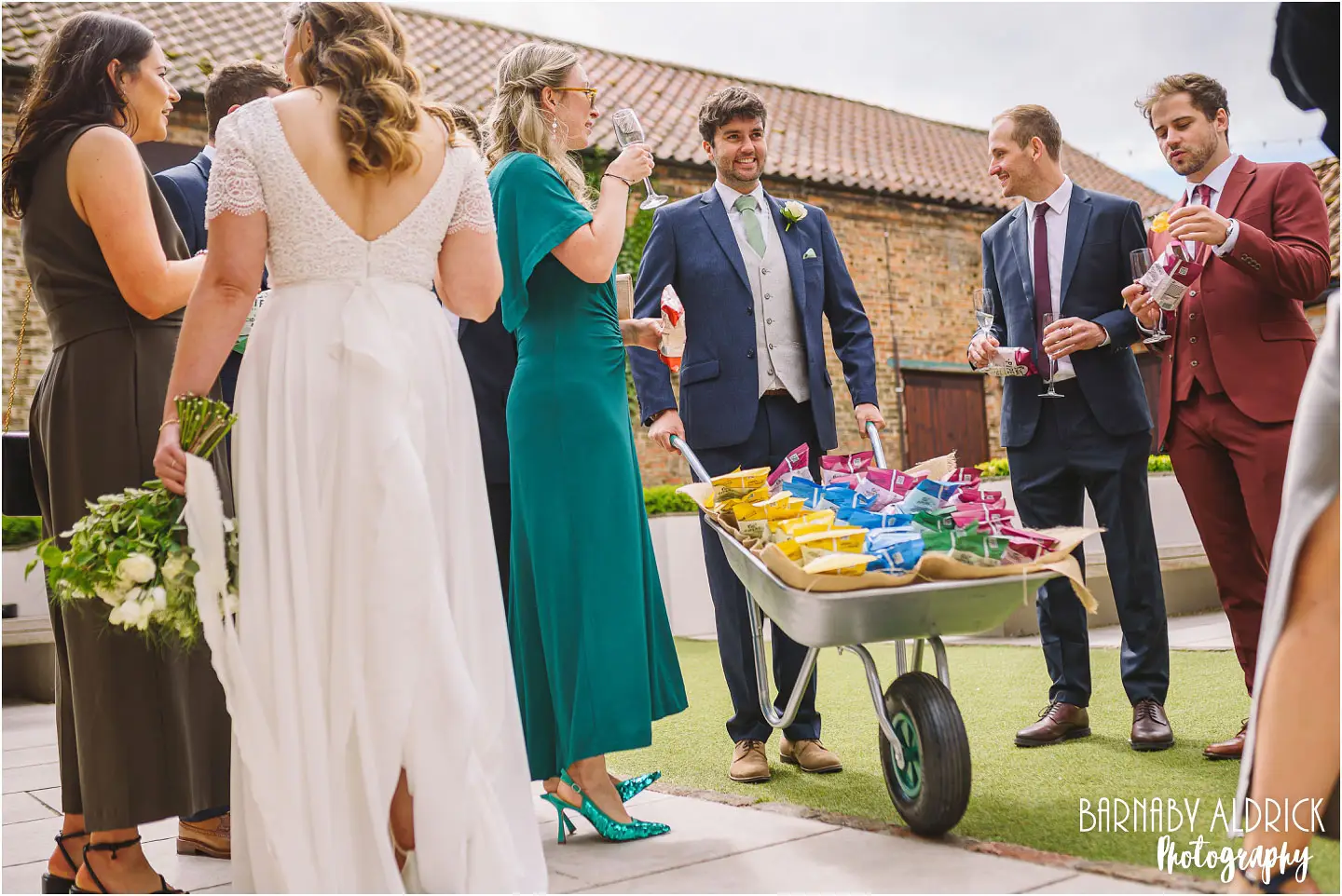 Candid wedding photo of a wheelbarrow of crisps at The Normans wedding venue in Yorkshire