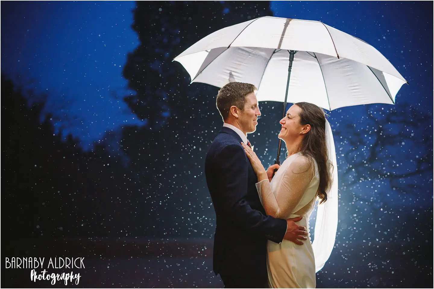 Amazing evening wedding flash photography in the rain at Goldsborough Hall near Knaresborough in Yorkshire