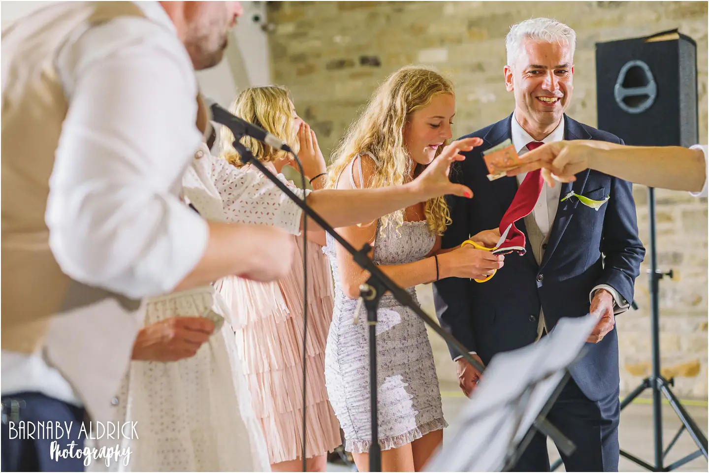 Fun wedding photos of the Italian tradition of cutting and auctioning off the tie at a wedding