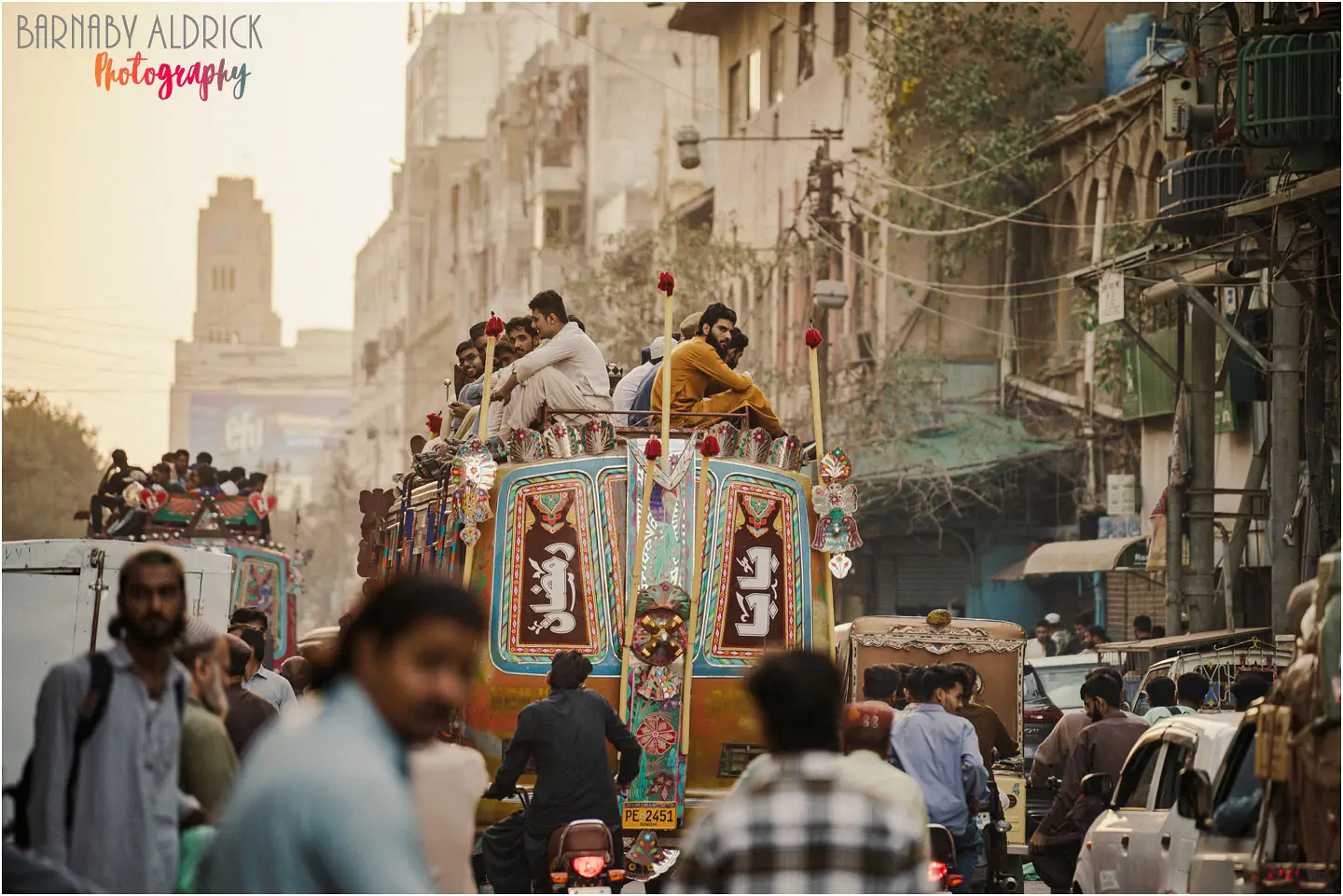 Riding on the roof of buses on near Bolton Market on Jinnah Road in Karachi in Pakistan
