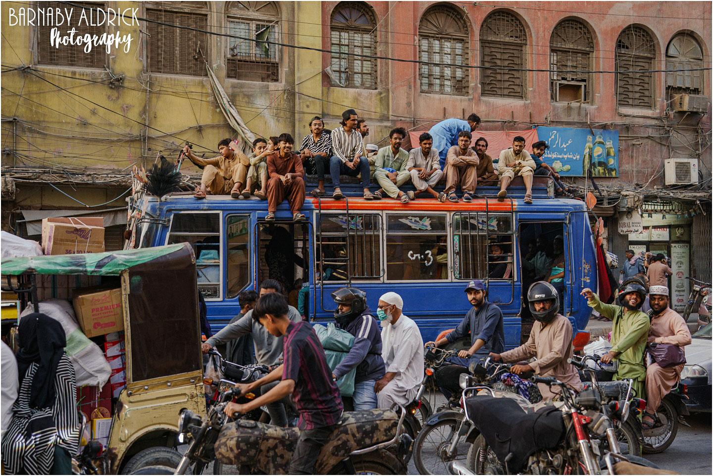 Riding on the bus roof on Jinnah Road in Karachi Pakistan